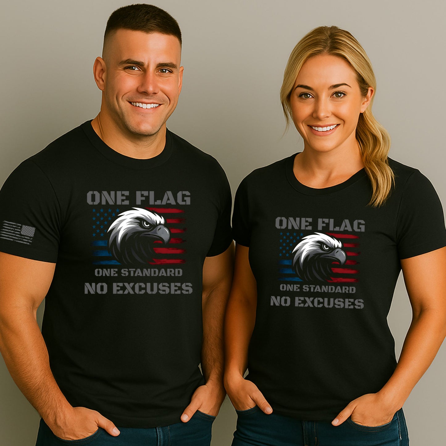 Man and woman wearing black ‘One Flag One Standard No Excuses’ t-shirts with American flag and eagle graphic and flag on the sleeve, on a gray studio background.