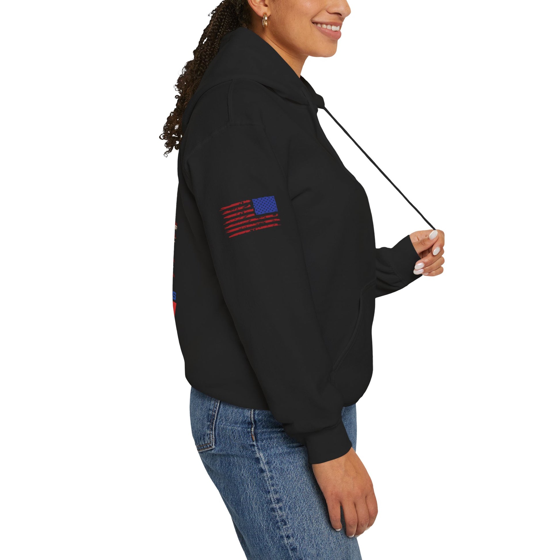 Female model wearing black unisex hoodie, side view; U.S. flag patch on sleeve, white background.