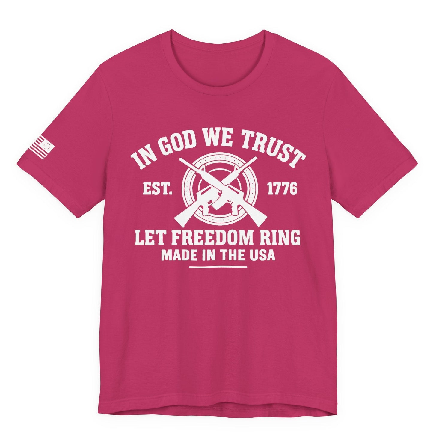 Berry Pink unisex t-shirt with white “IN GOD WE TRUST” crossed-rifles graphic and “LET FREEDOM RING” text, left-sleeve flag graphic, white background.
