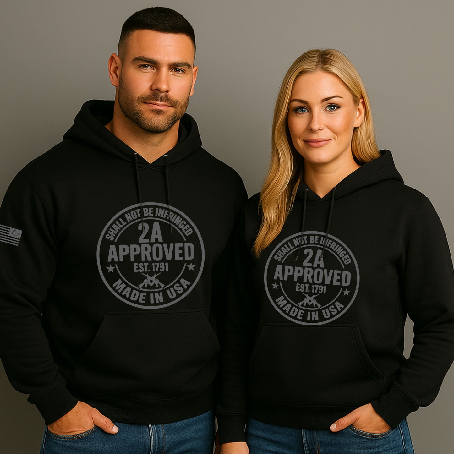 Two models wearing black pullover hoodies with a circular ‘2A Approved’ logo on a gray background