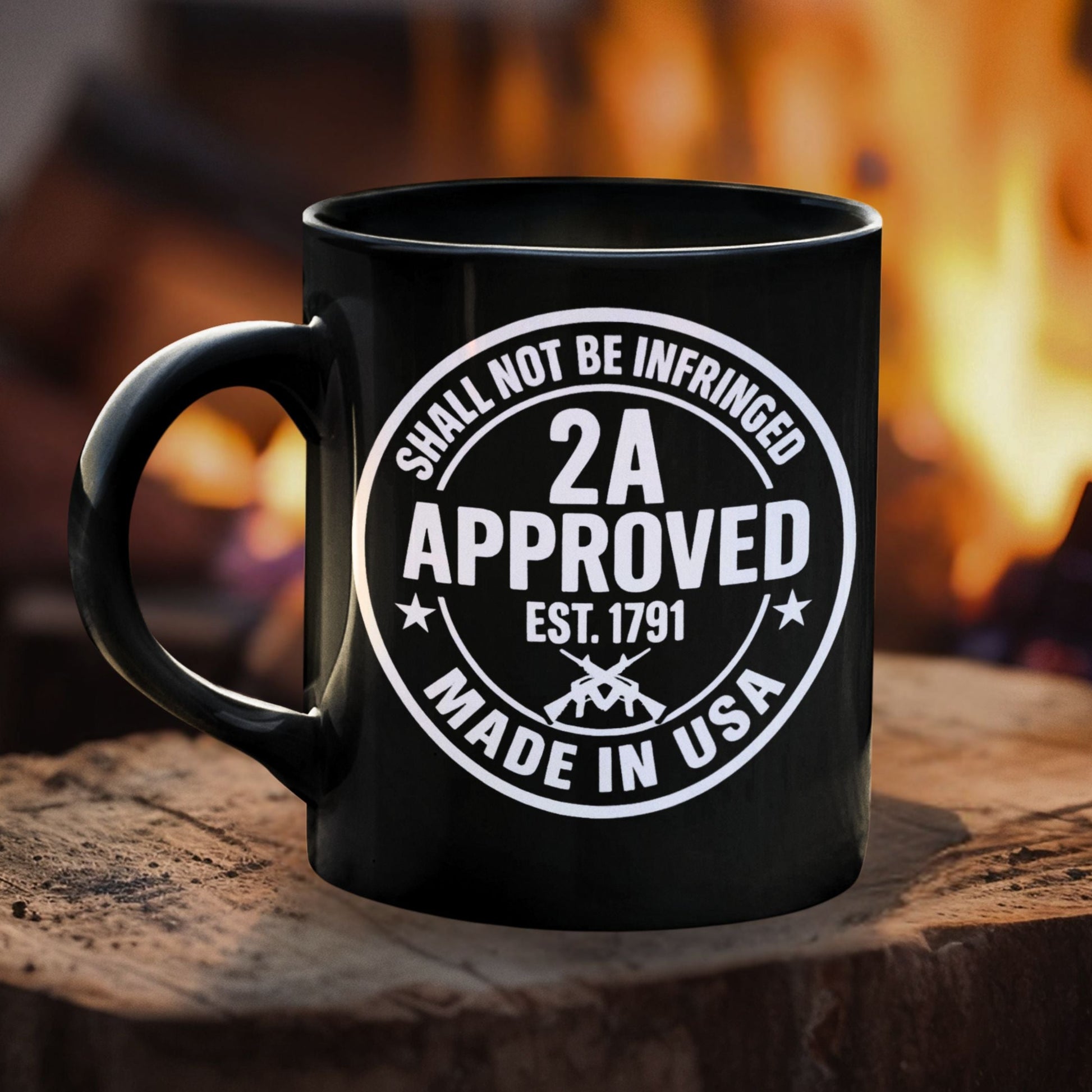 Black ceramic mug with white “2A Approved” seal graphic on front, fireplace background.