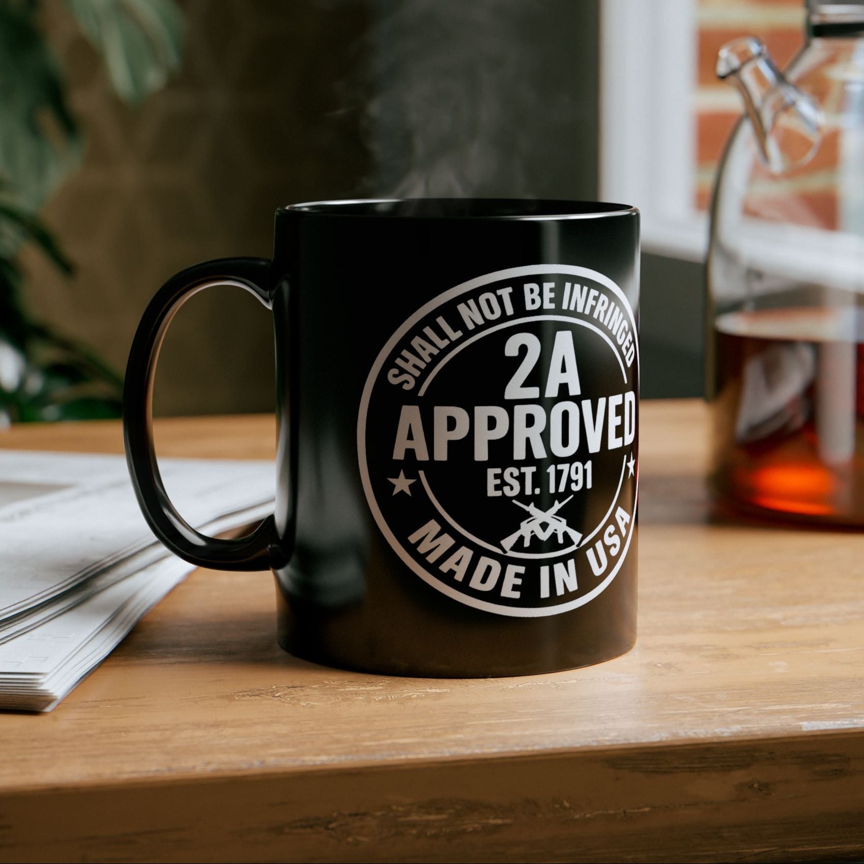 Black ceramic mug with “2A Approved” white design on a wood table with steam