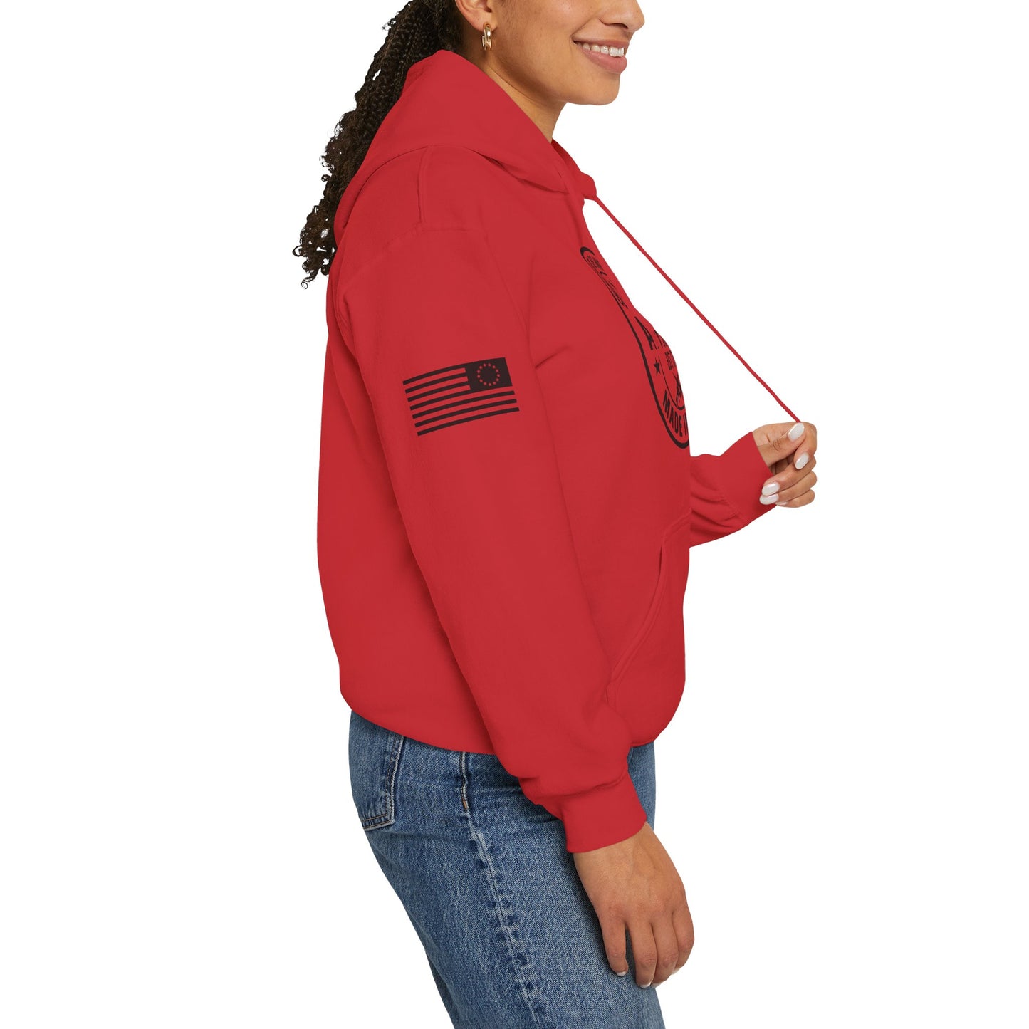 Side view of model wearing red pullover hoodie with American flag sleeve print on a white background