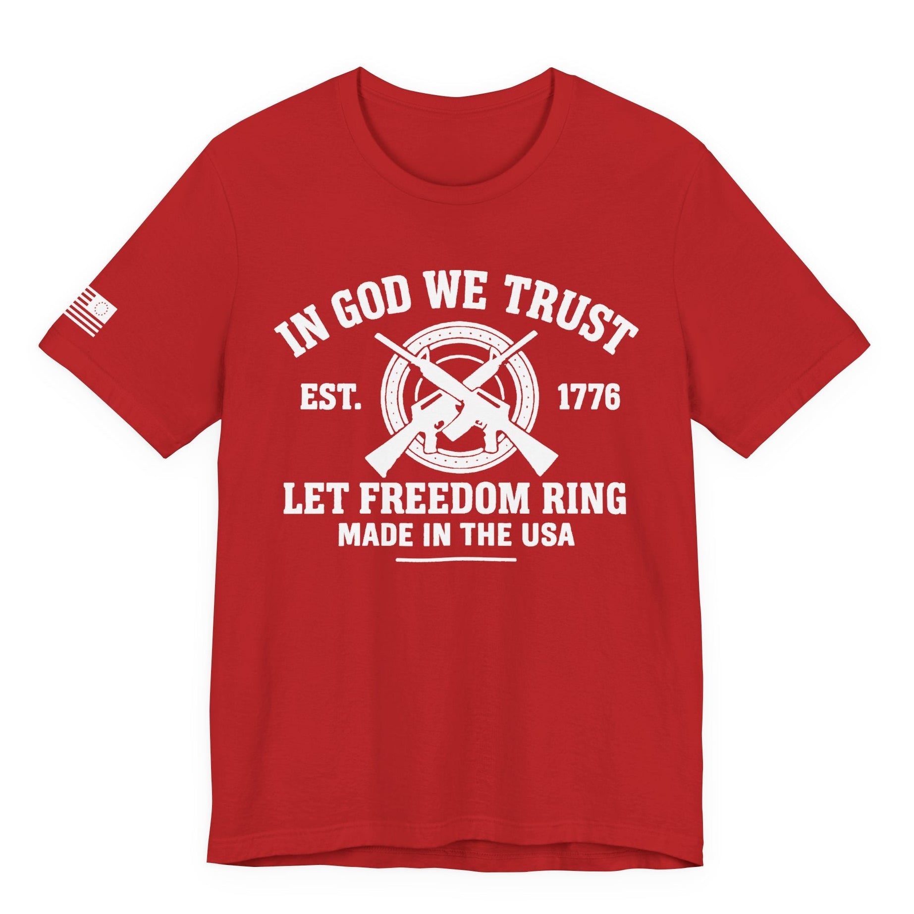 Red unisex t-shirt with white “IN GOD WE TRUST” crossed-rifles graphic and “LET FREEDOM RING” text, left-sleeve flag graphic, white background.